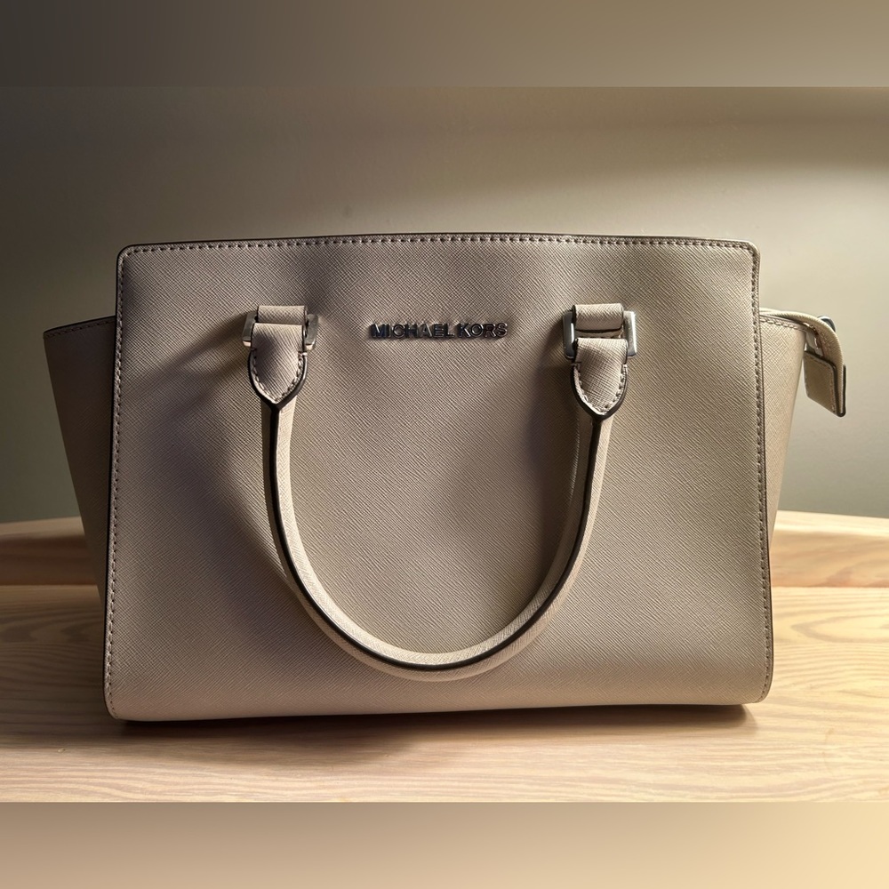 Sand/light khaki colored Michael Kors convertible purse with silver hardware.